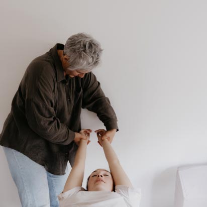 Chiropractor stretching out a patient's arms.